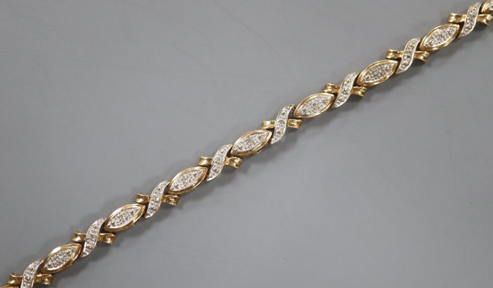 A modern 375 yellow metal and diamond chip set line bracelet, 18.9cm, gross 7.4 grams.